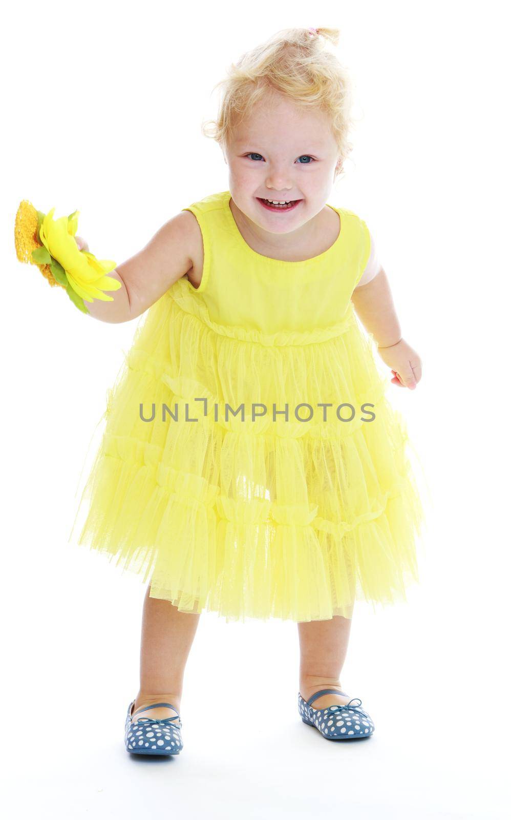 Little girl in a long yellow dress. Isolated on white background .