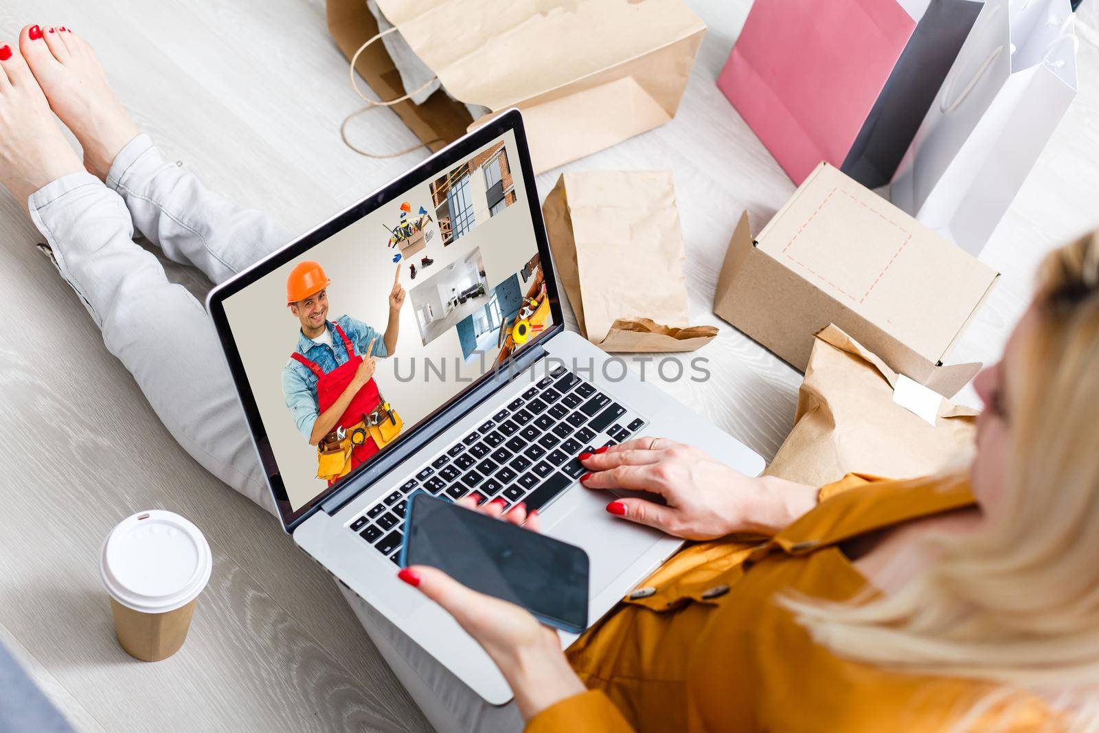 young manual worker displaying laptop over white background