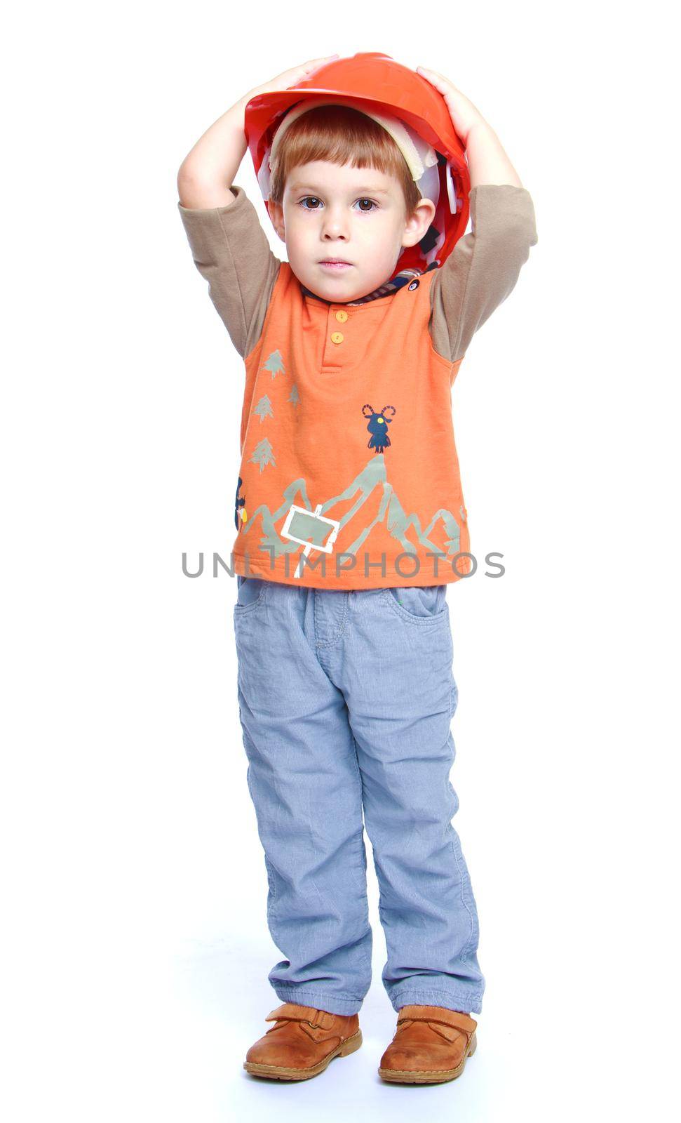 Cheerful little boy in the construction helmet.Isolated on white background portrait.