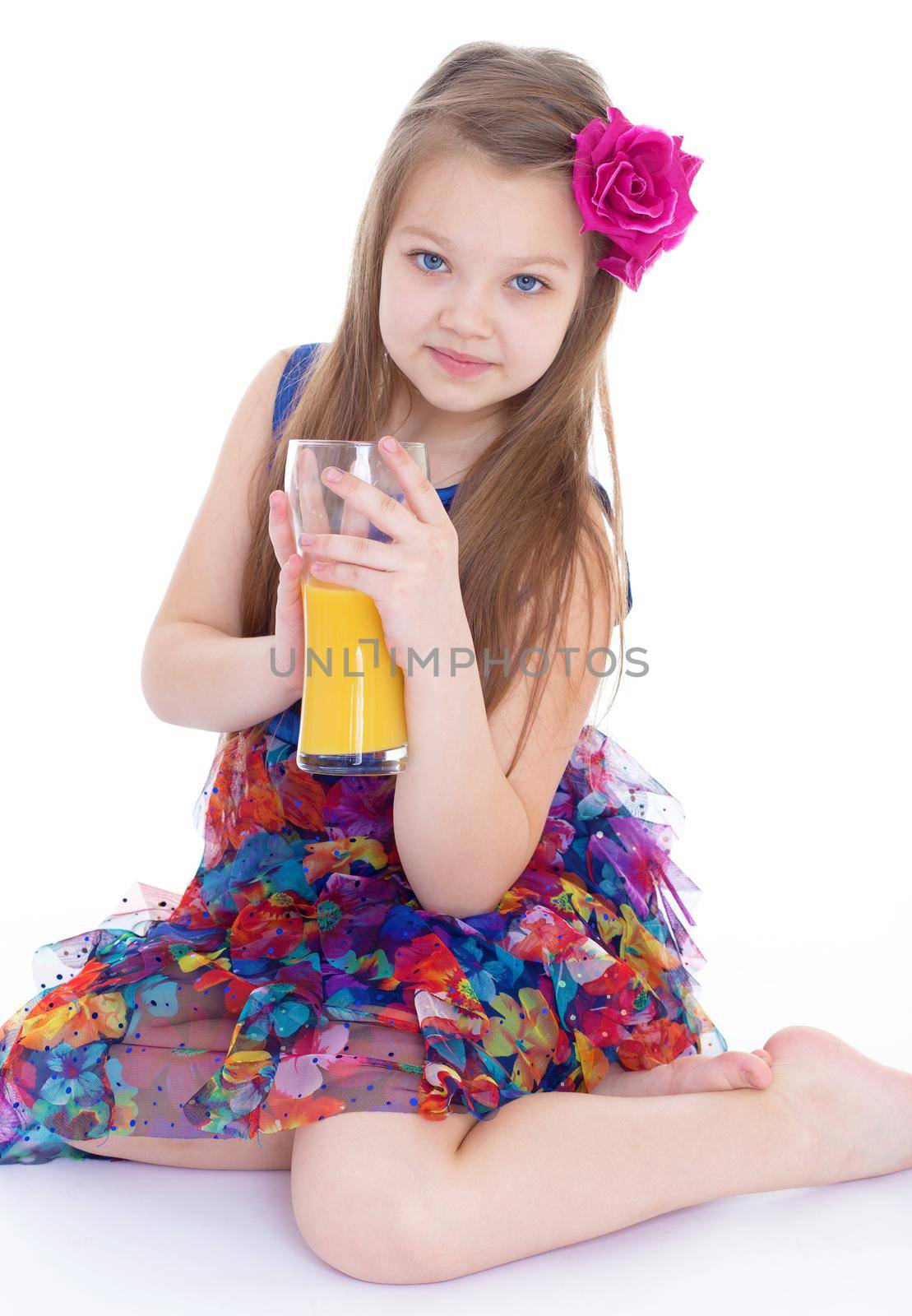 girl, fashion, rose in her hair and orange juice in a glass- Portrait of happy little girl drinking orange juice