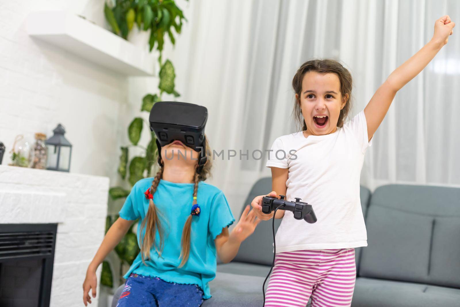 two little girls using glasses of virtual reality headset. concept of modern technologies