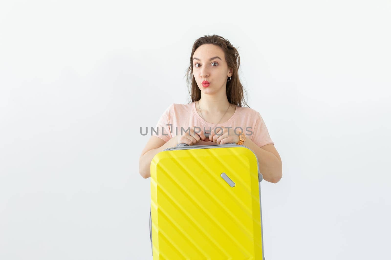 Trip, travel and holidays concept - woman with her yellow suitcase