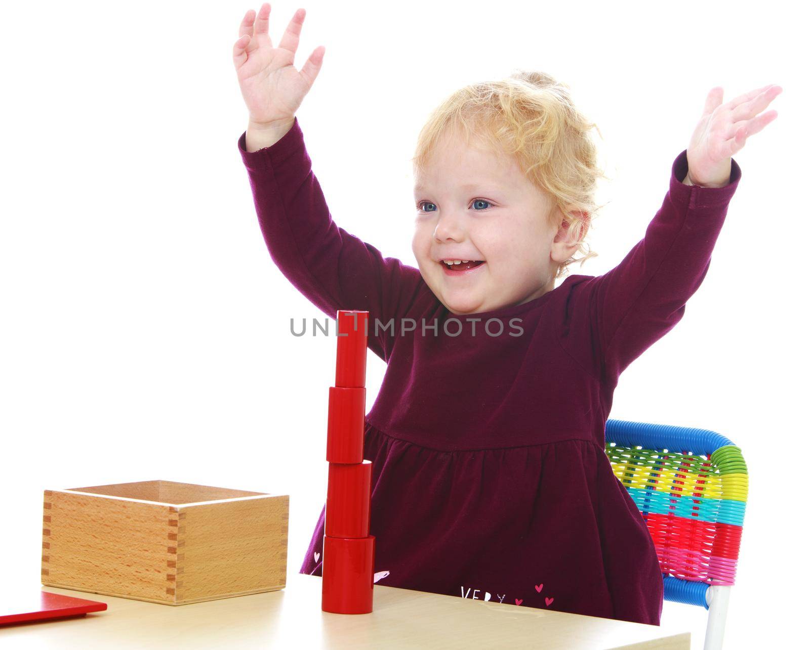 A little girl raised her arms up with joy.Isolated on white background .