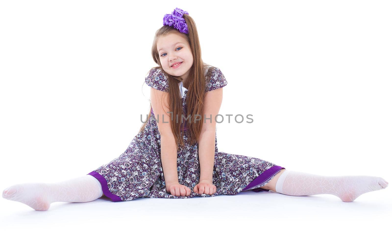 A beautiful young girl sits on a twine. by kolesnikov_studio