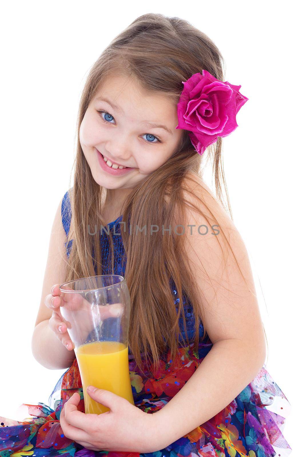 girl, fashion, rose in her hair and orange juice in a glass- Portrait of happy little girl drinking orange juice