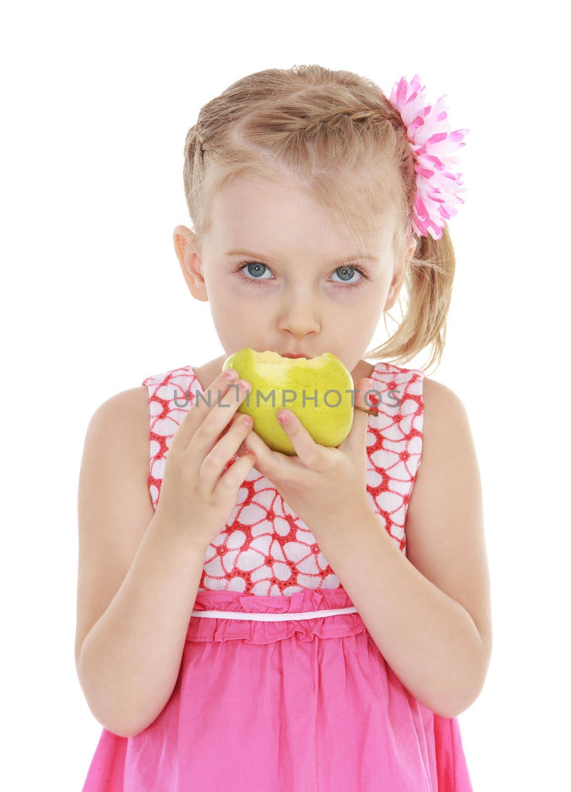 Little girl bites green apple. Isolated on white background .