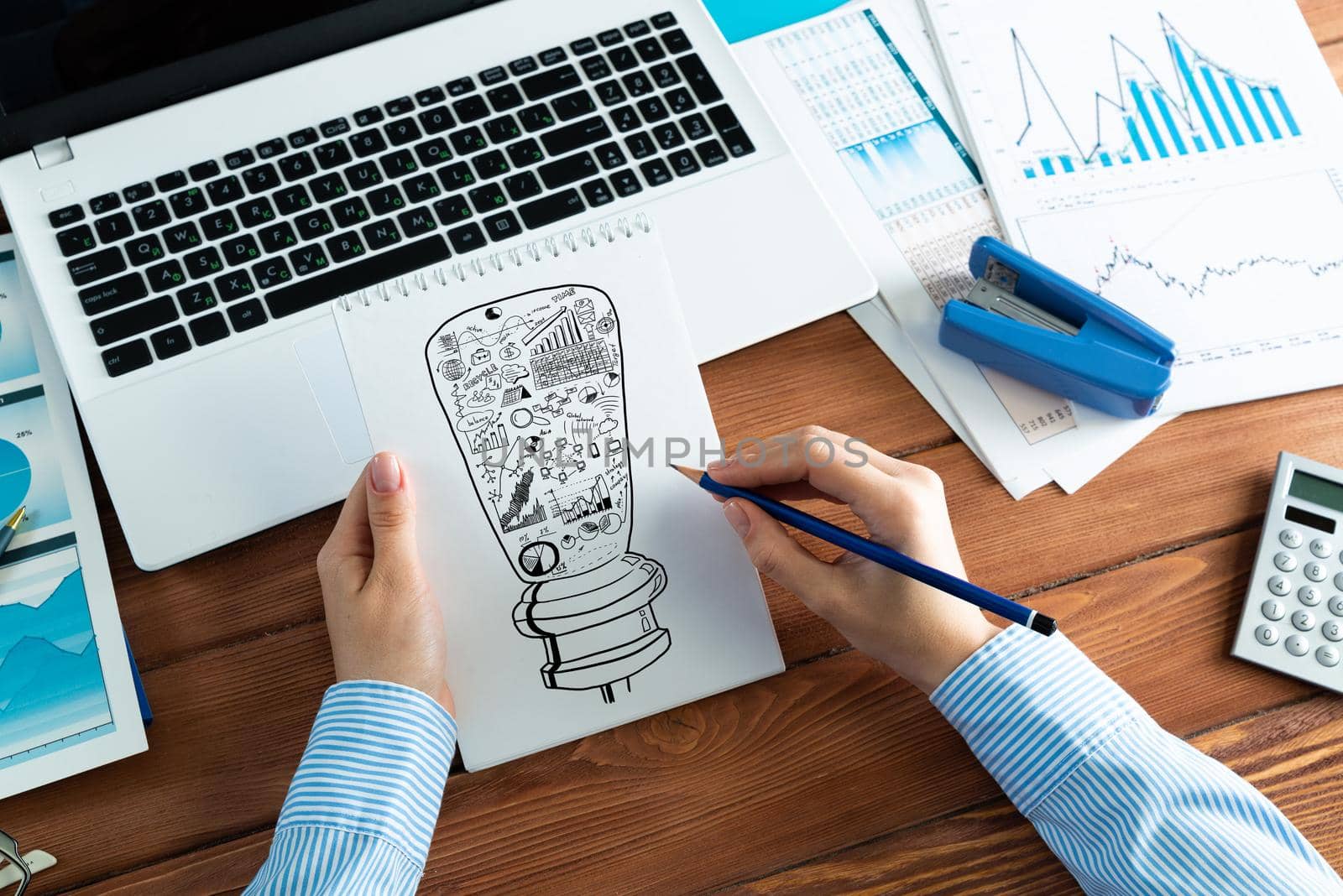 close-up, woman draws business notes in her notebook. Business Innovation Concept