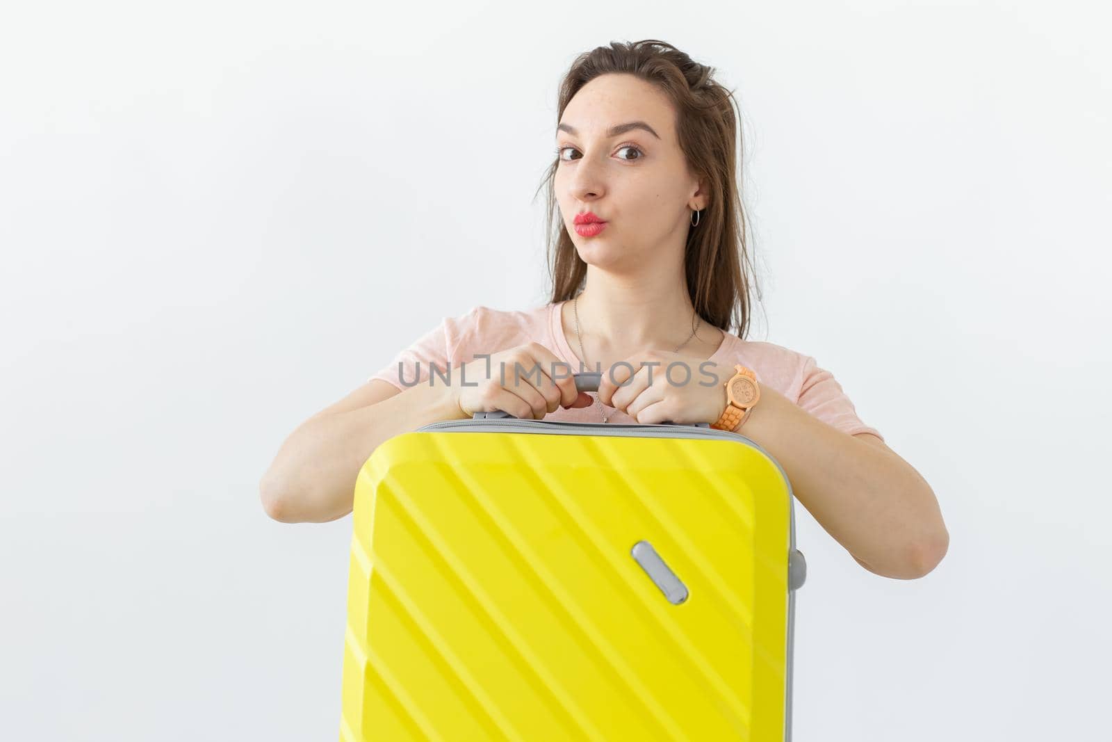 Trip, travel and holidays concept - woman with her yellow suitcase