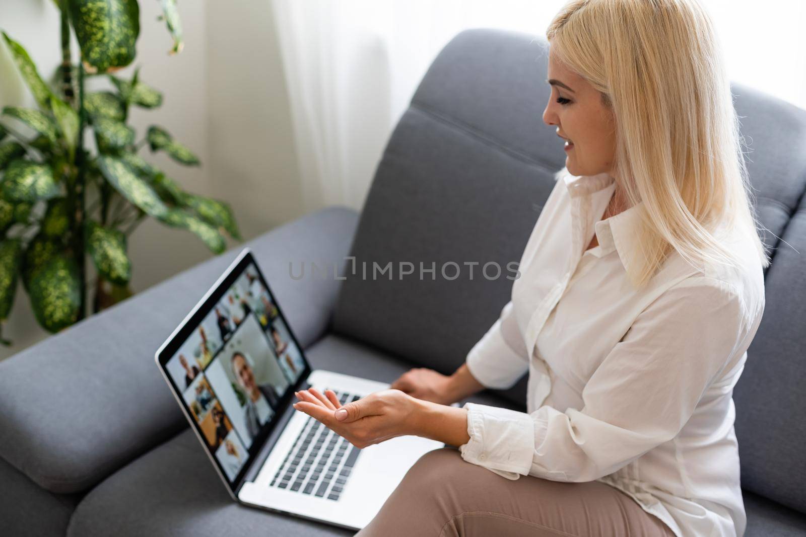 Woman using laptop indoor. woman listens to online lecture by Andelov13