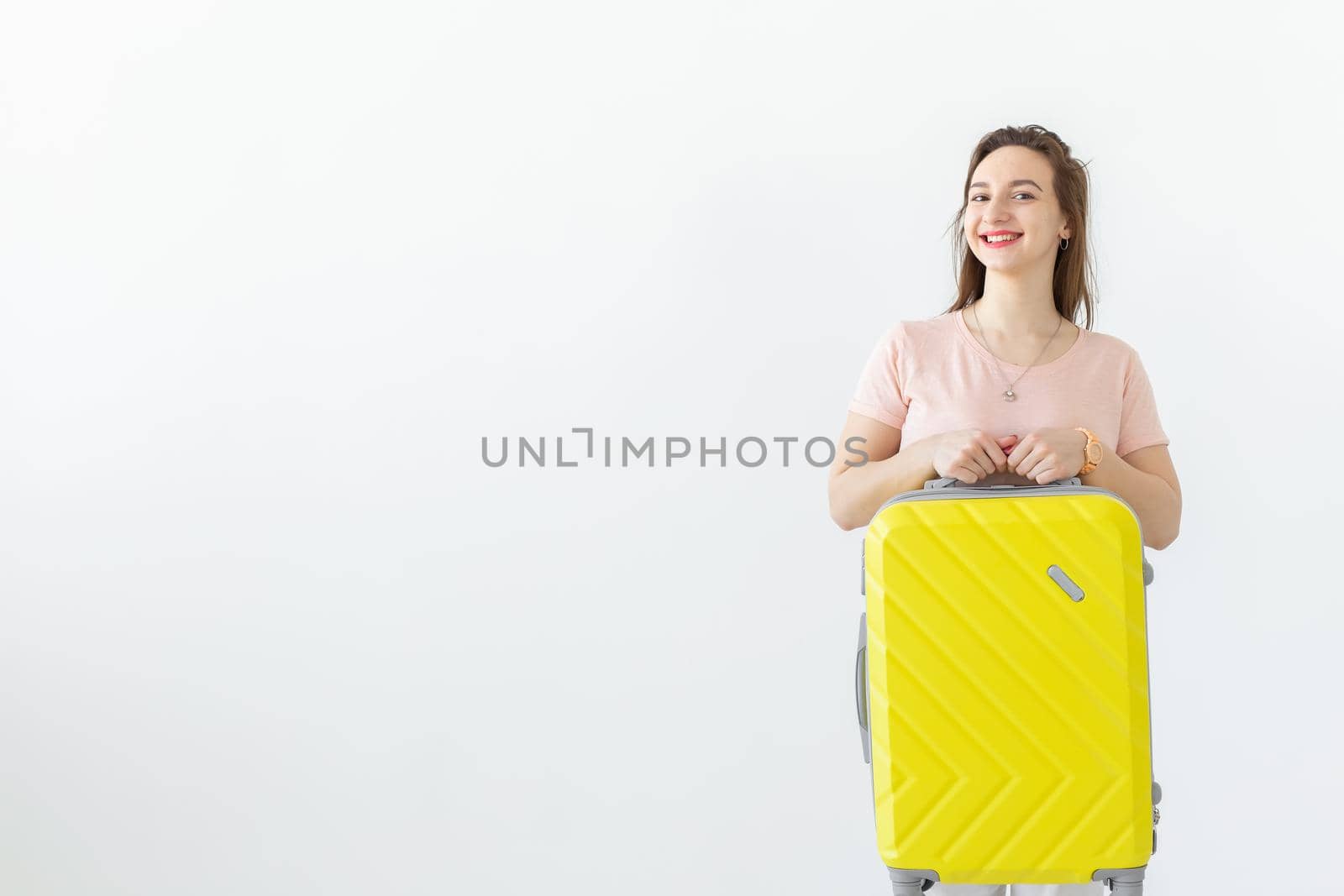 Trip, travel and holidays concept - woman with her yellow suitcase