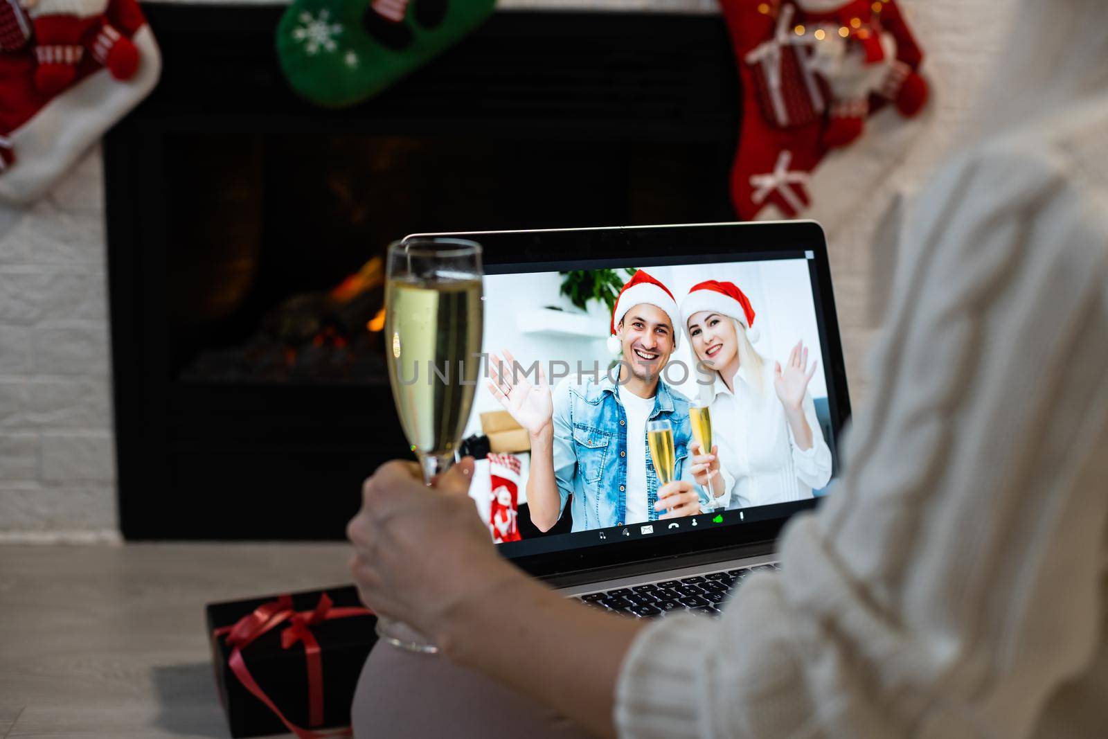 Laptop on the christmas table. Video call with the family in times of coronavirus. by Andelov13