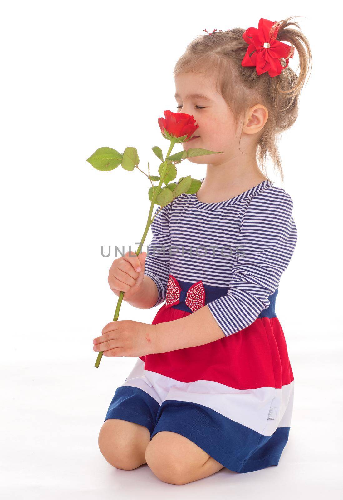 Little girl smelling roses on white background