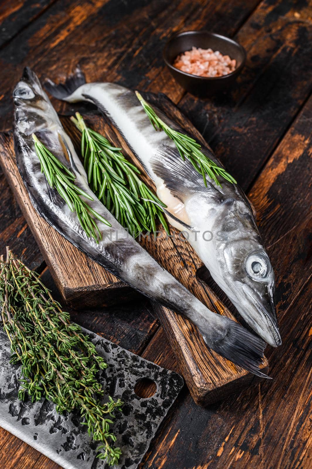 Whole fresh Raw icefish on a wooden cutting board. Wooden background. Top view by Composter