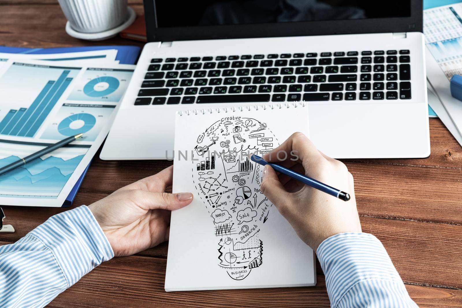 close-up, woman draws business notes in her notebook. Business Innovation Concept