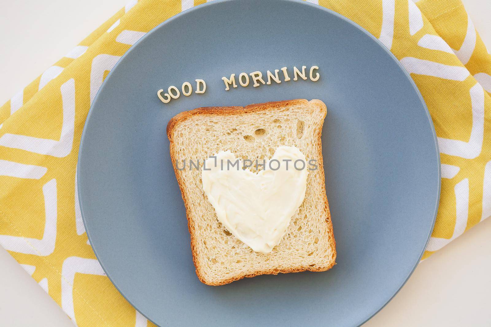 sandwich for breakfast in the form of heart with blue cheese on a plate and napkin bright inscription good morning
