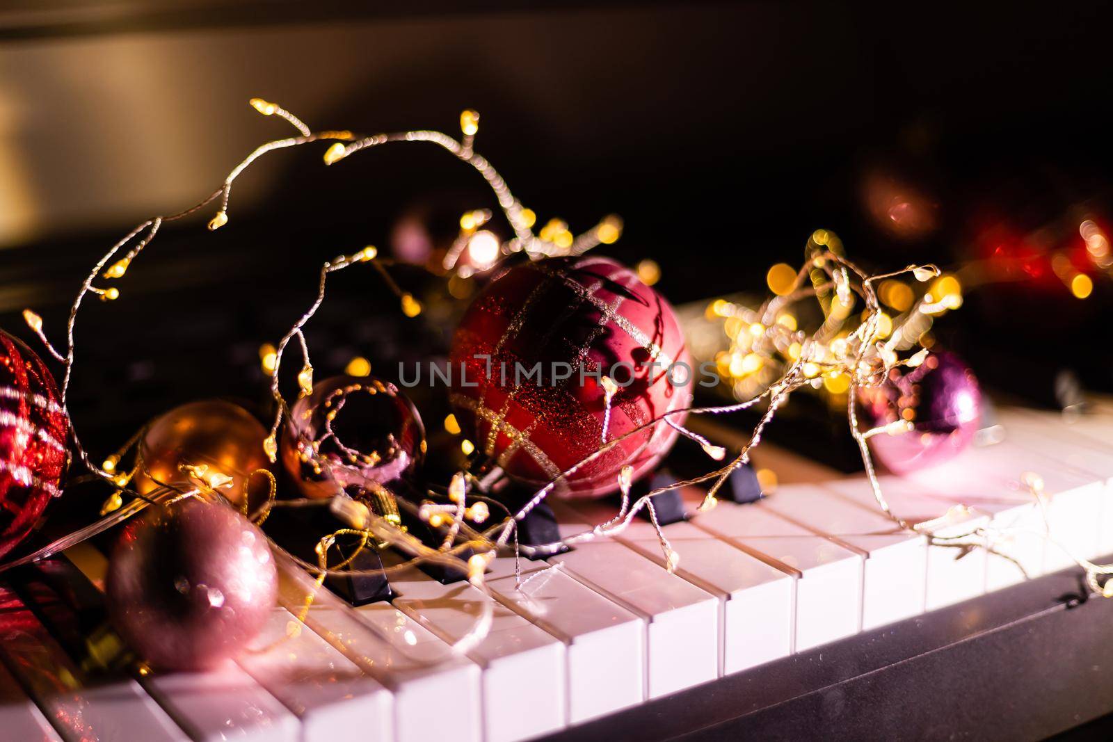 Piano keys with Christmas decorations, closeup