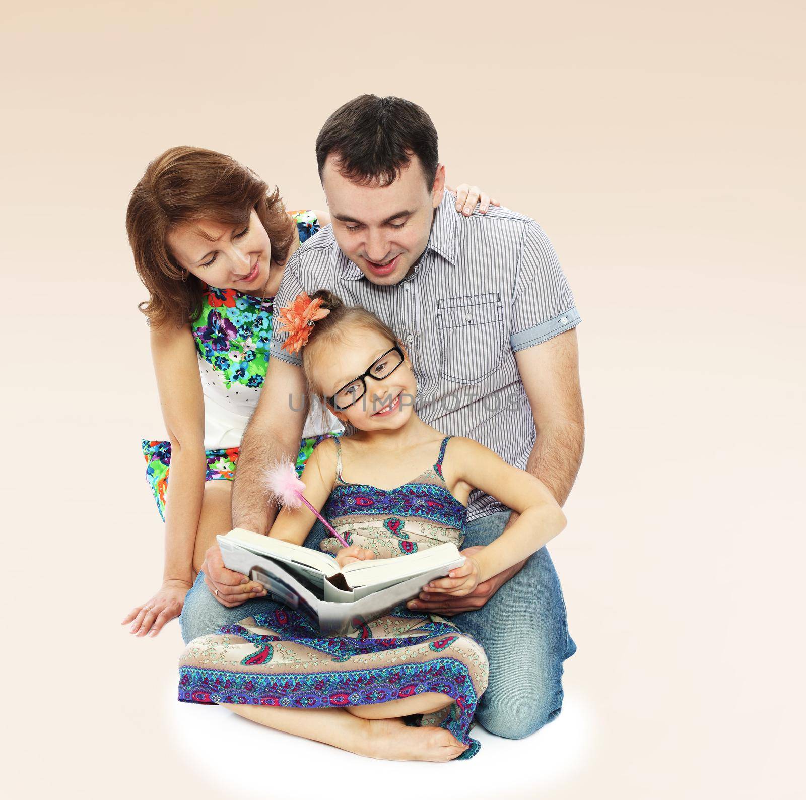 Cheerful young family together to read books.