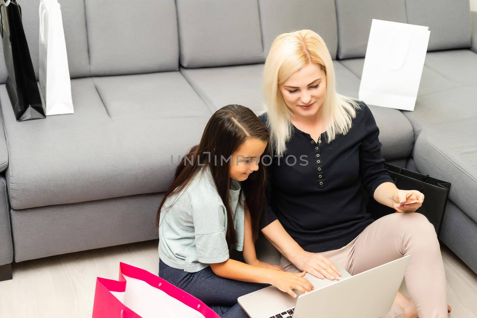 picture of happy mother and child with laptop computer, shopping online by Andelov13