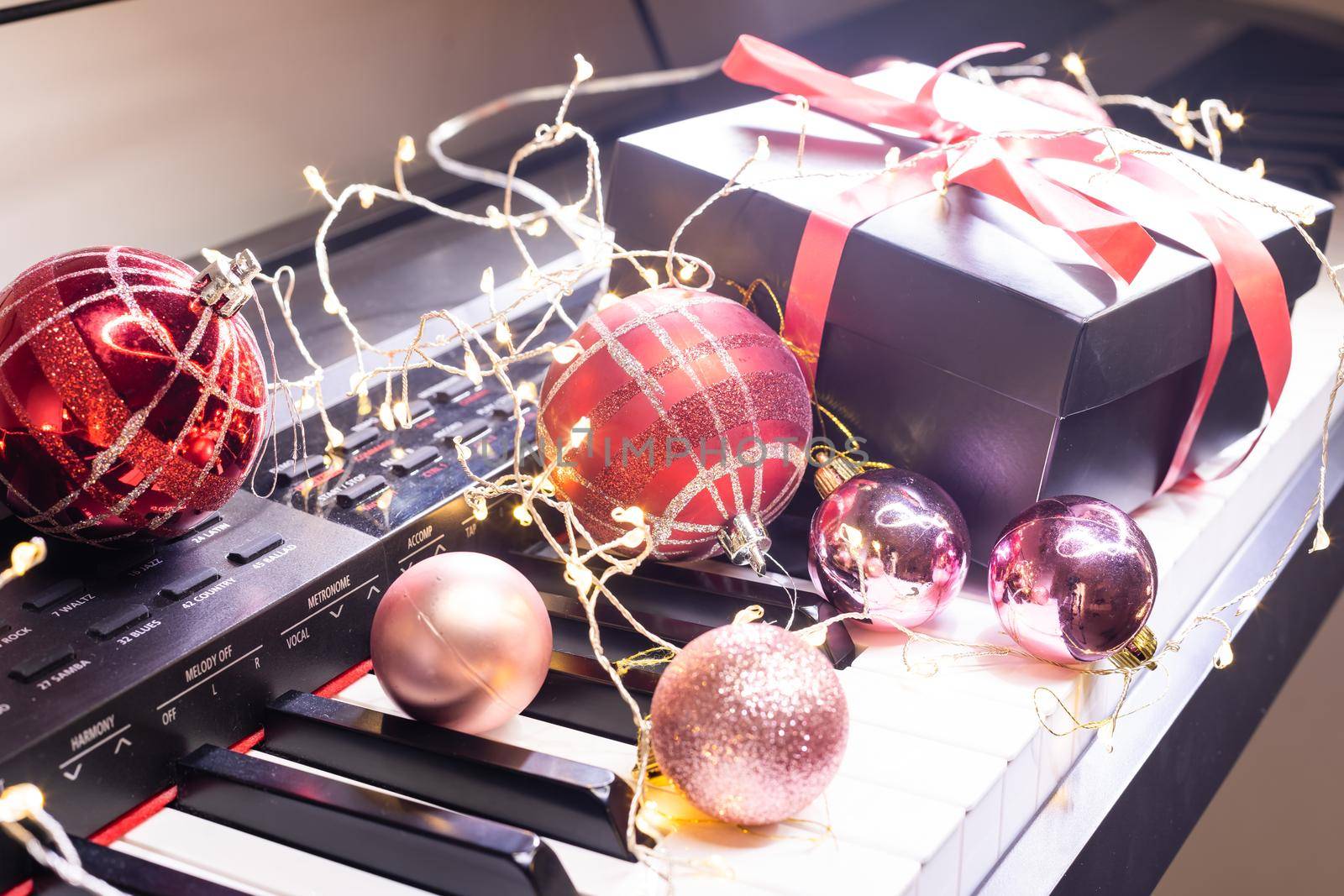 Piano keys with Christmas decorations, closeup
