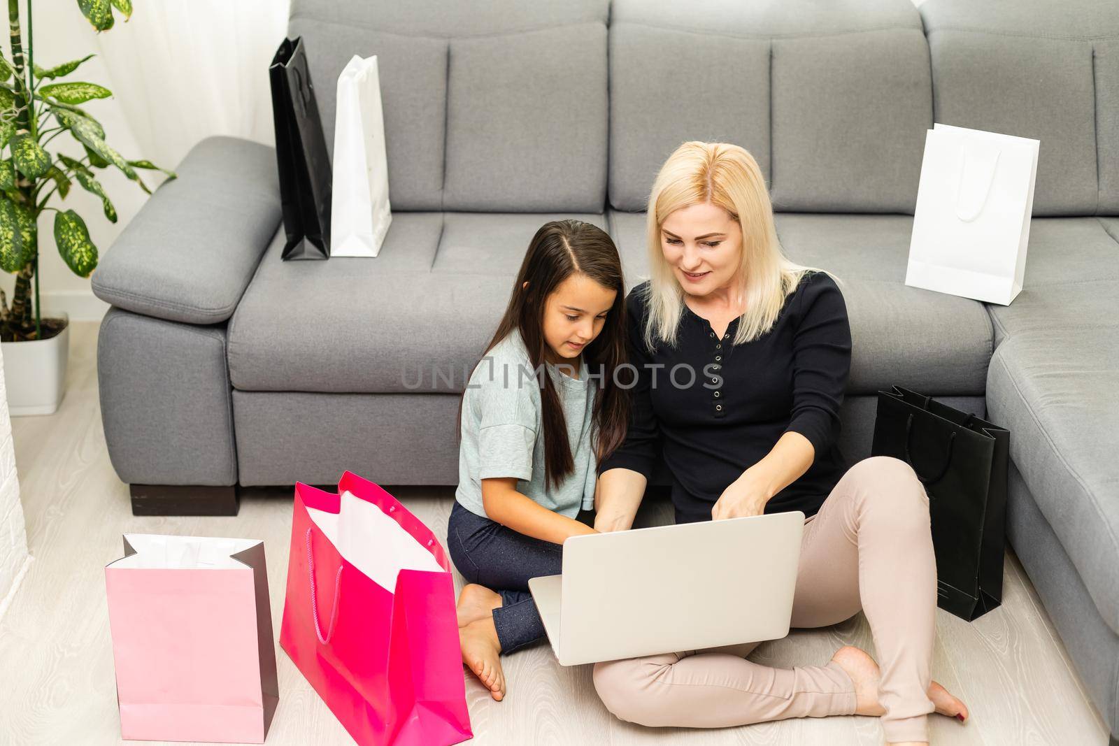picture of happy mother and child with laptop computer, shopping online by Andelov13