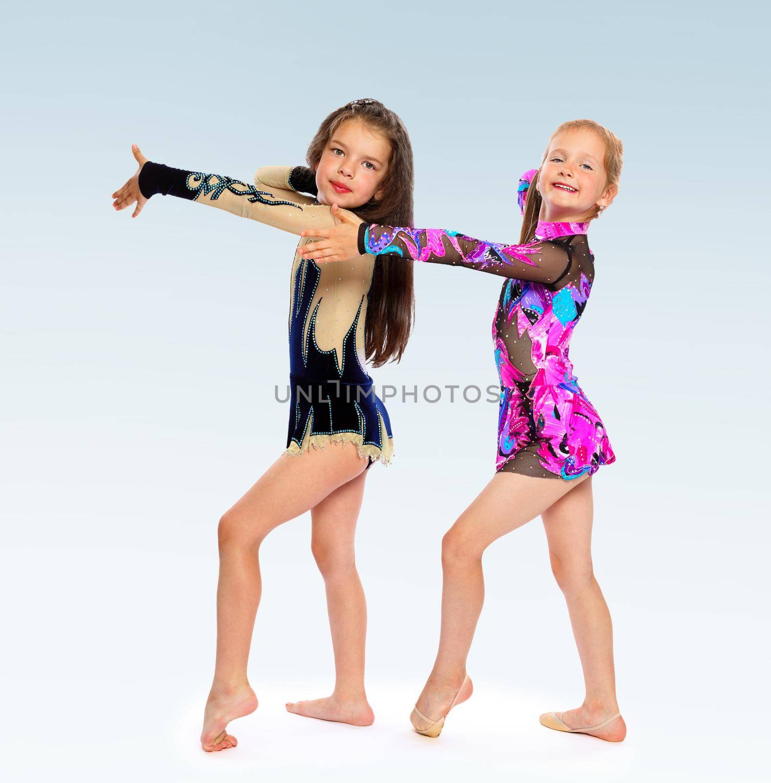 two girls gymnast gymnastic exercises shows costumes.