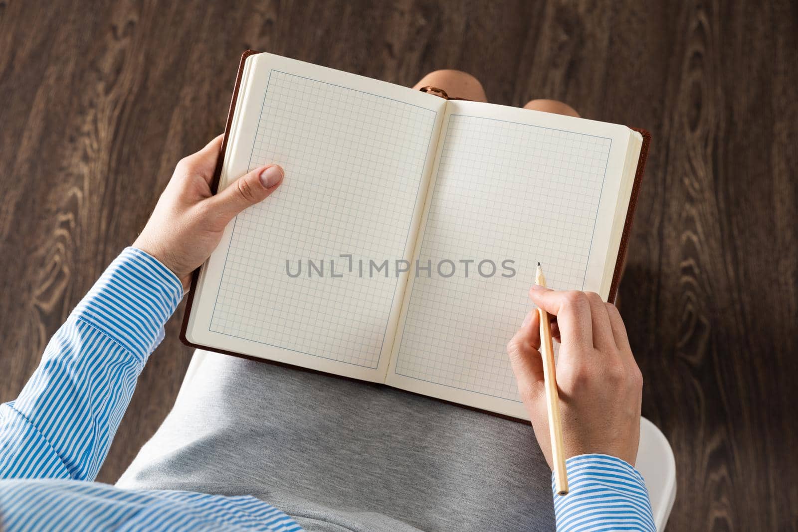 close-up a female hands with notebook and pencil