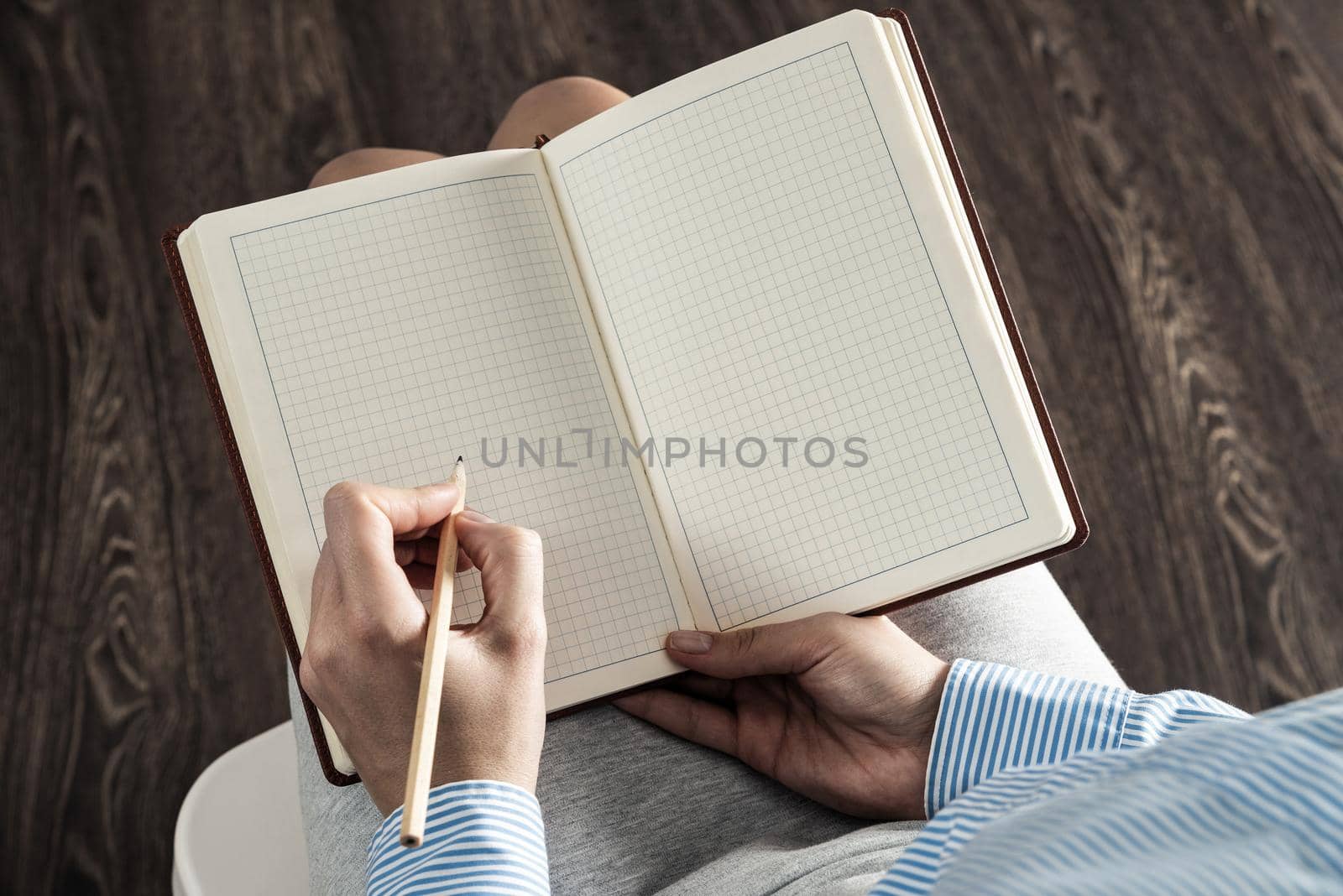 close-up a female hands with notebook and pencil