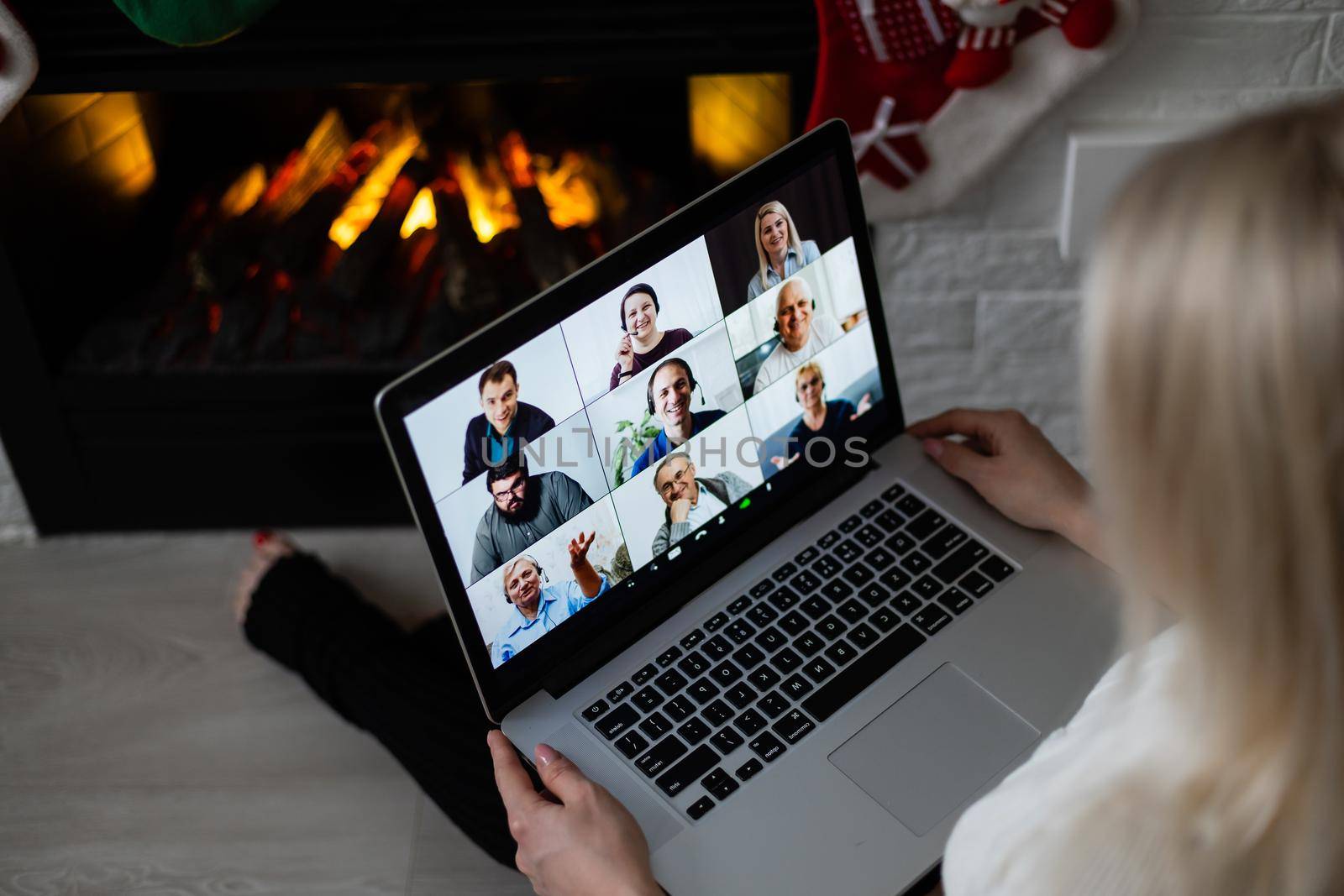 A young smiling woman making video call on social network with family and friends on Christmas day.