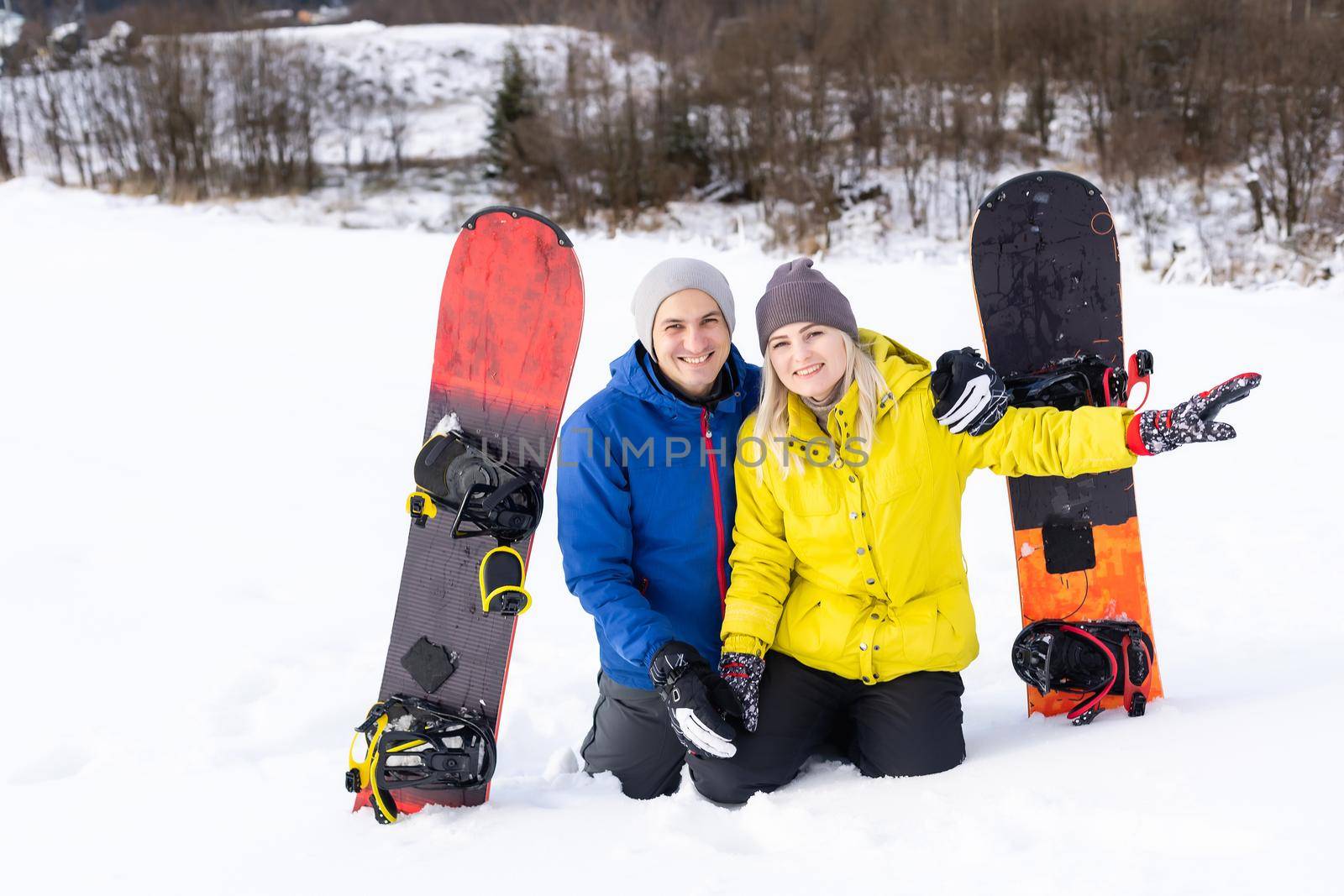 family with snowboards at winter resort