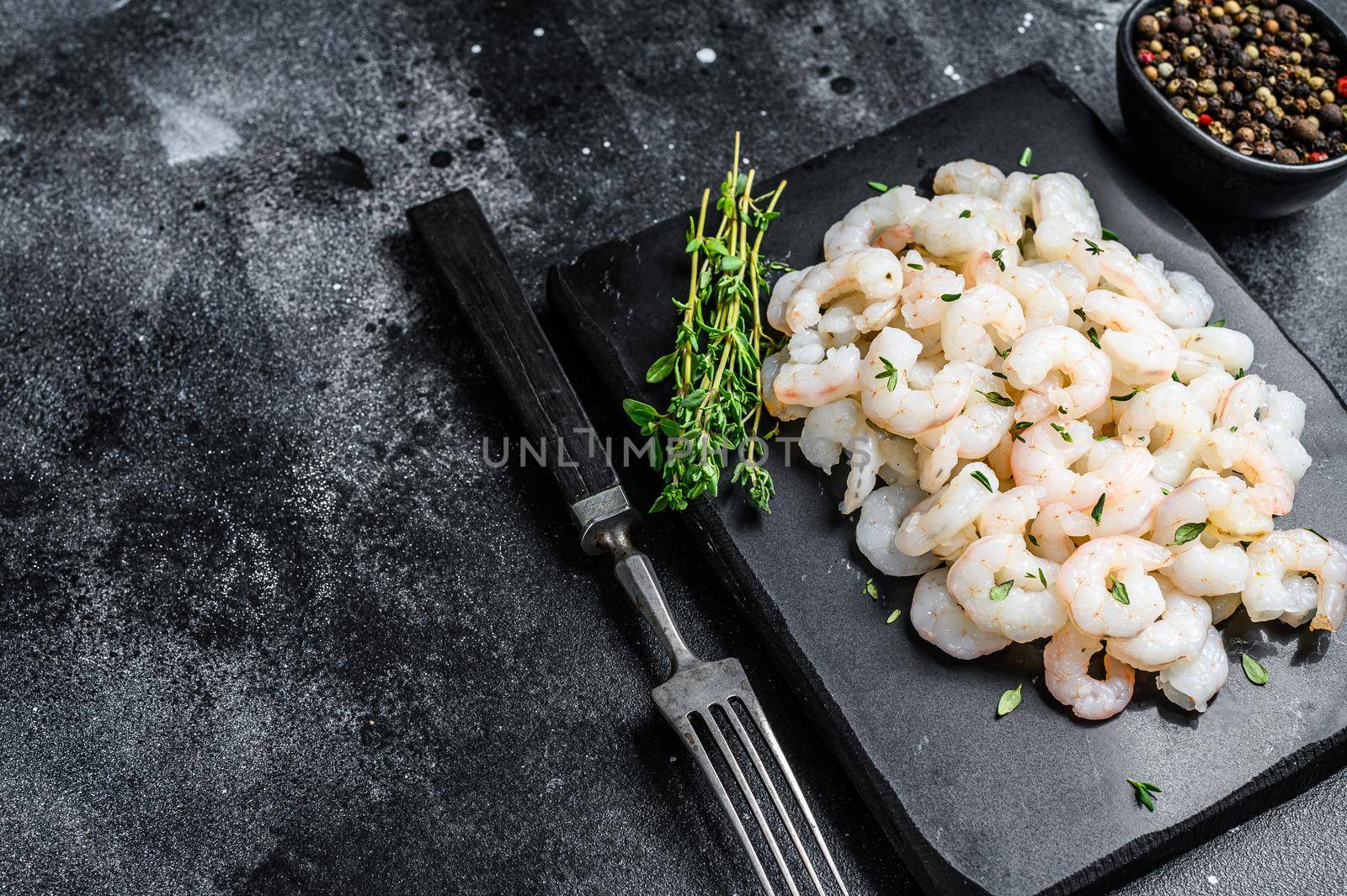 Peeled Shrimps, Prawns on a marble board. Black background. top view. copy space.
