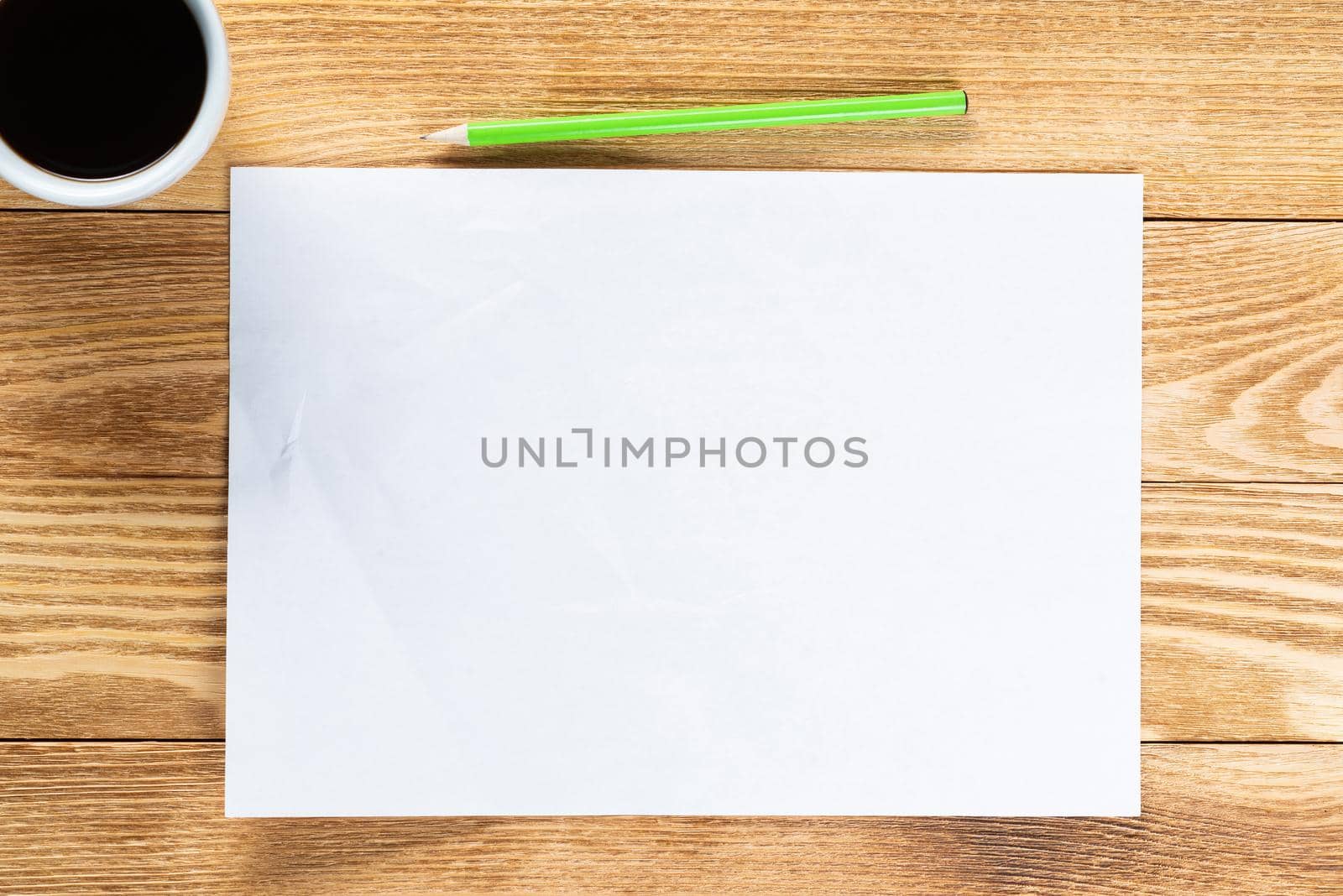 Flat lay wooden table with cup of coffee and paper. Blank white a4 format paper with pen. Space for writing and notification. Textured natural wooden background. Vintage copy space for creative design