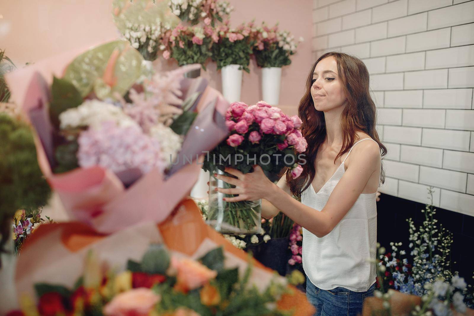 Girl with a flowers. Florist making a bouquet