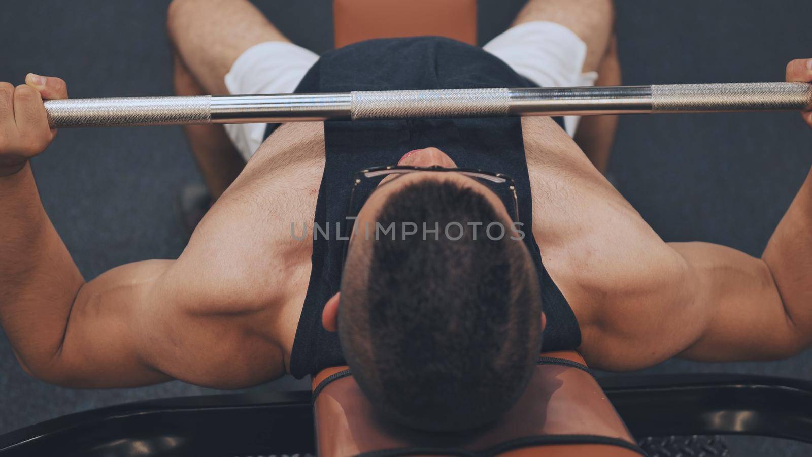 An Arab man pumps his chest in the gym. by DovidPro