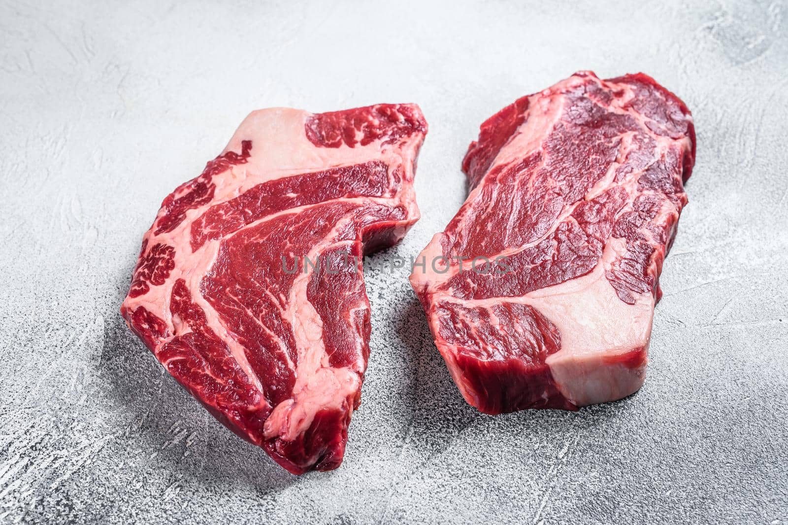 Raw chuck eye roll steaks premium beef meat. White background. Top view by Composter