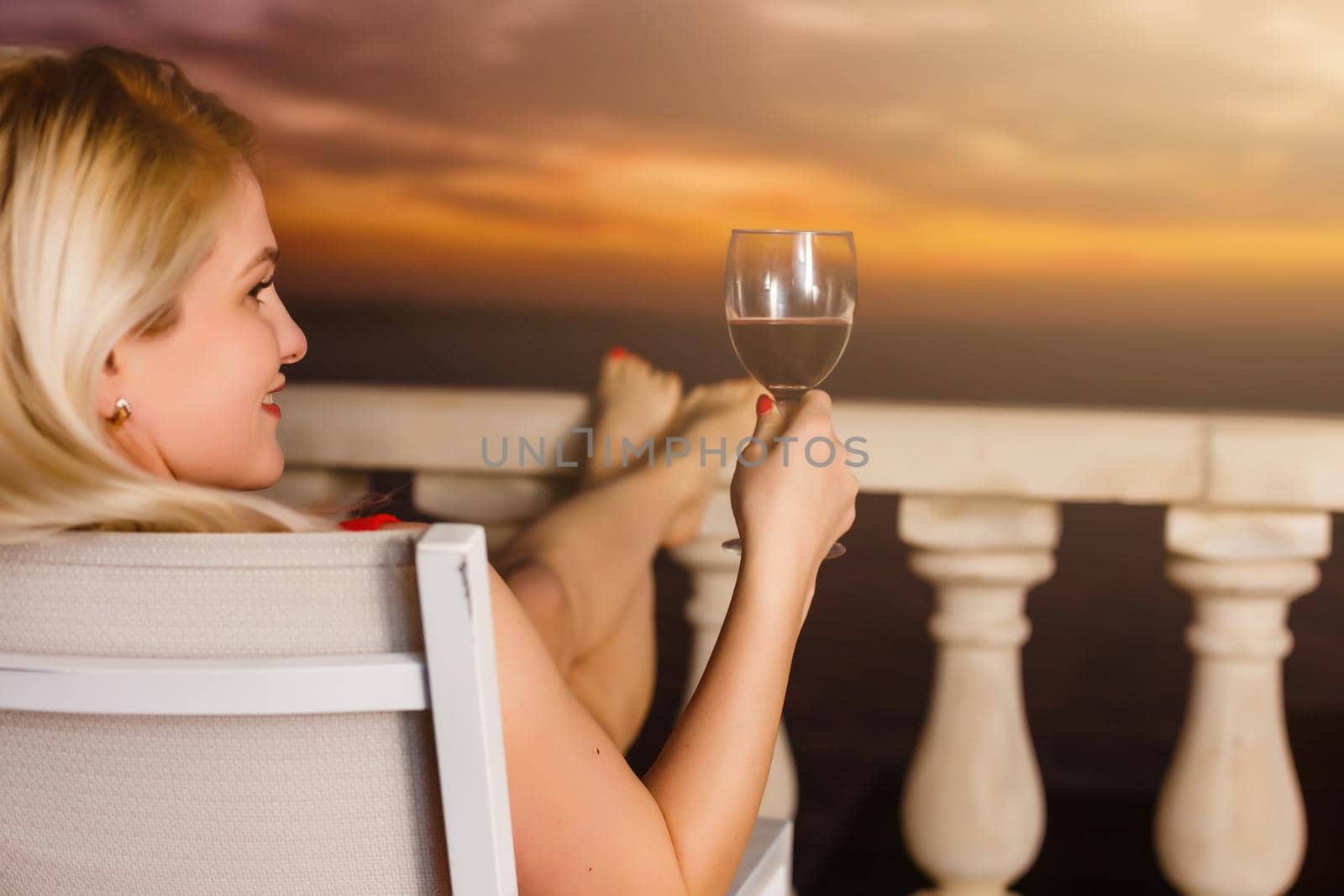 Woman admiring sunset from her balcony