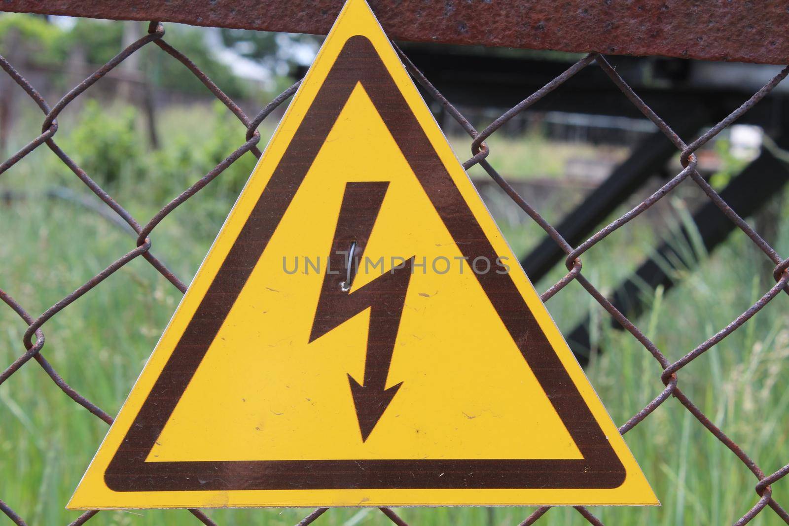 a sign of danger. Dark brown lightning against the yellow triangle by Shoba