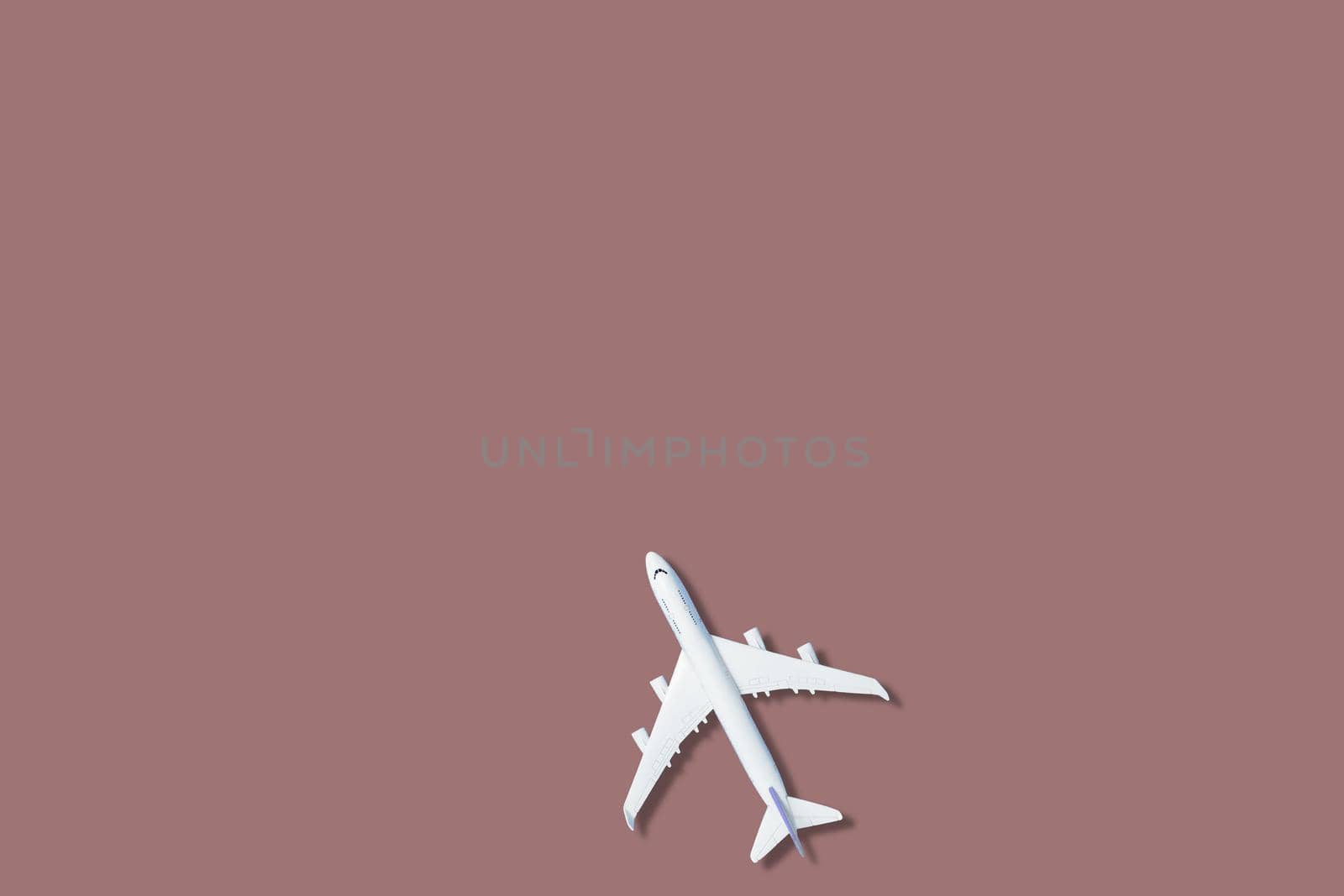 airplane figure on pink background
