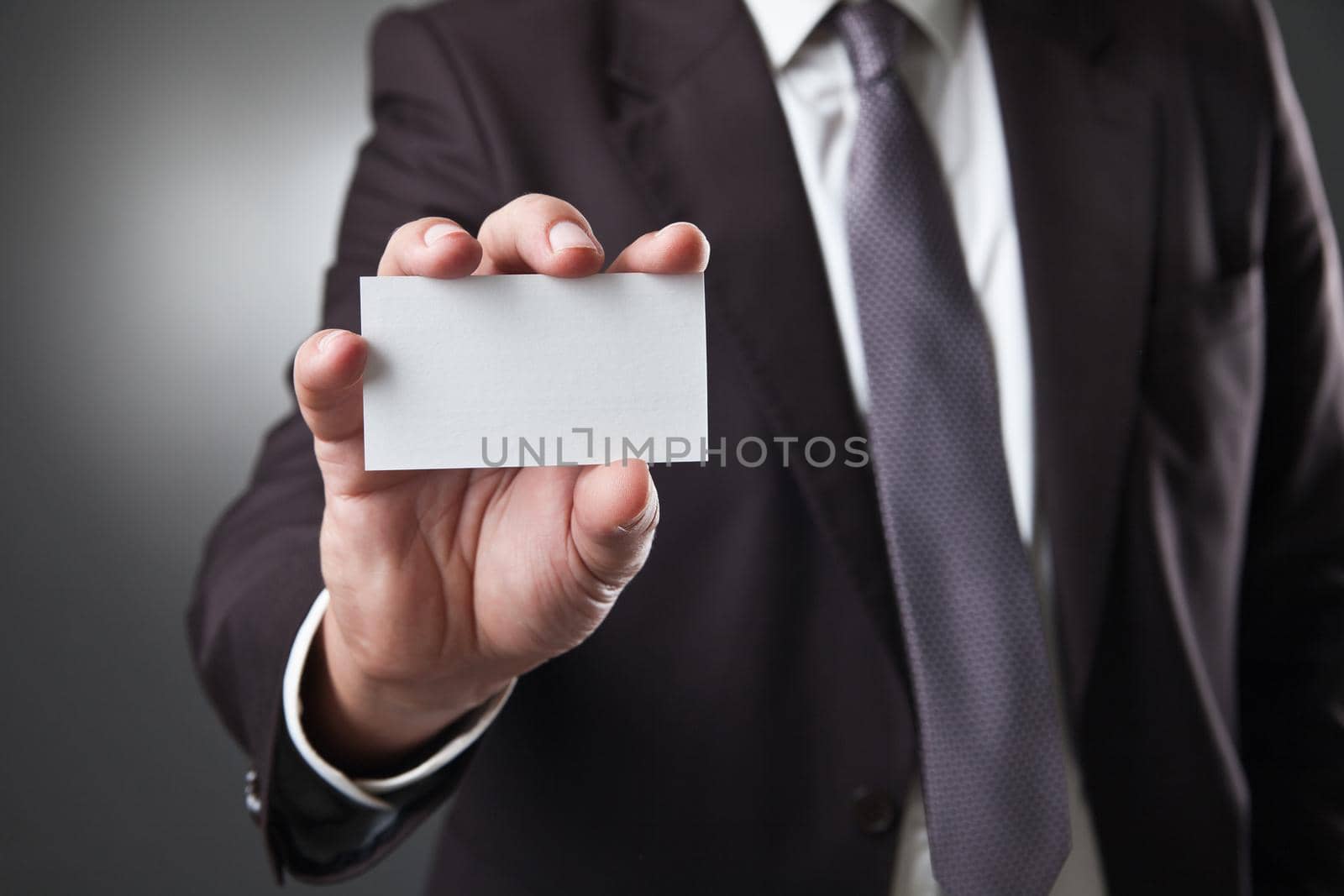 business man show card on dark grey background