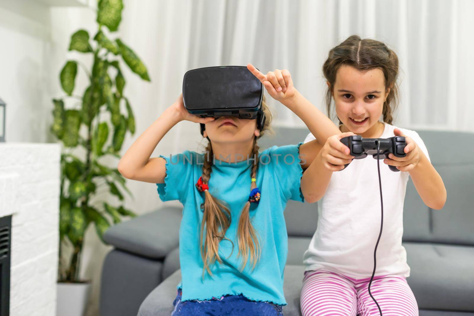 two little girls playing video games virtual reality glasses by Andelov13