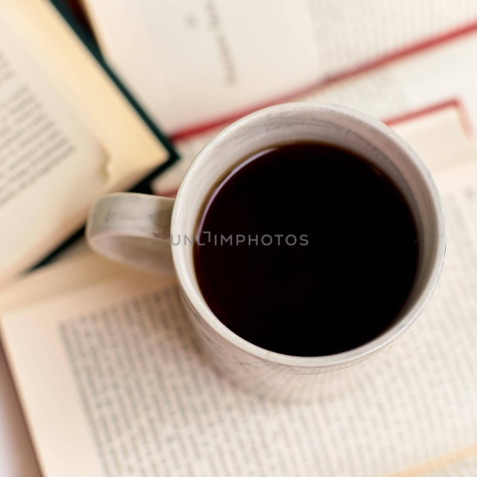 Open books and coffee mug on a book, top view by izik