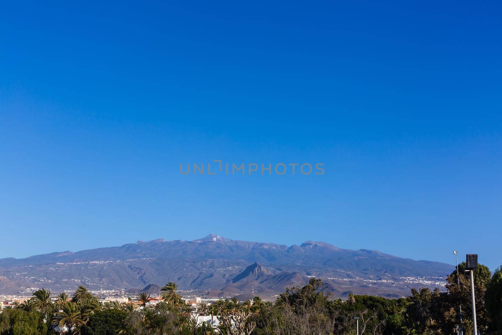 A sign with a mountain in the background. High quality photo