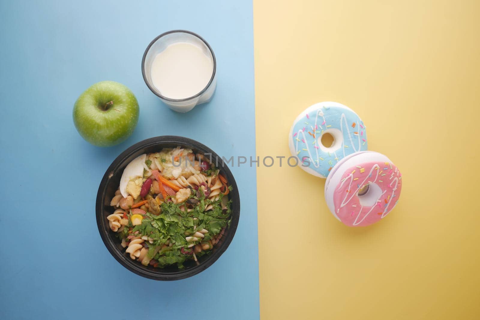 comparing healthy and junk food concept on table .