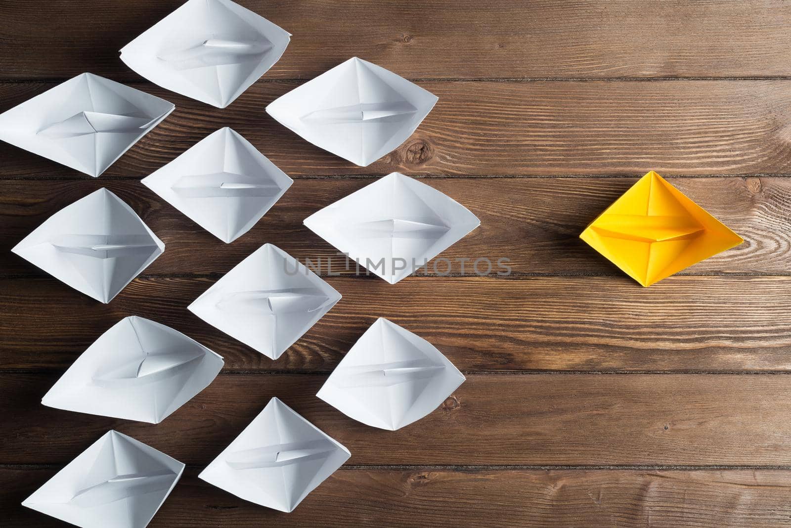 Set of origami boats on wooden table