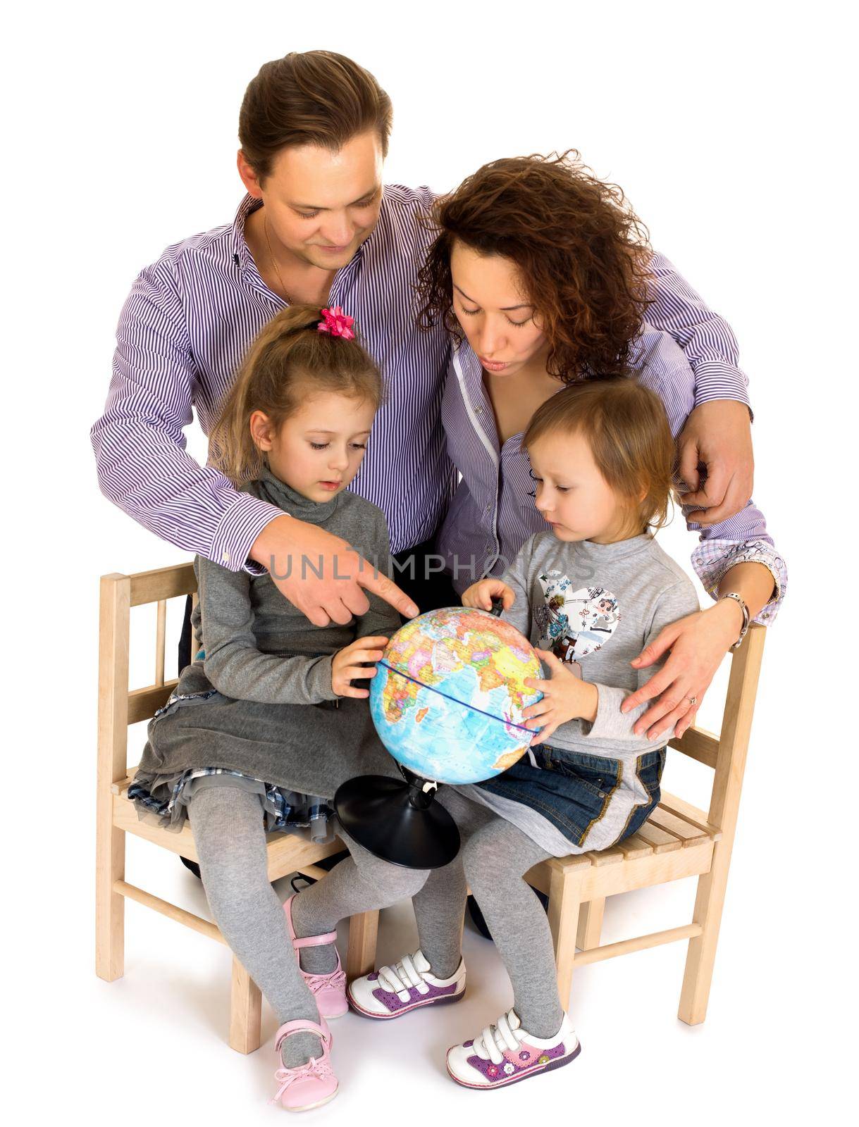 Young family, parents and two daughters are studying Globe .Papa shows a finger on the mainland - Isolated on white background