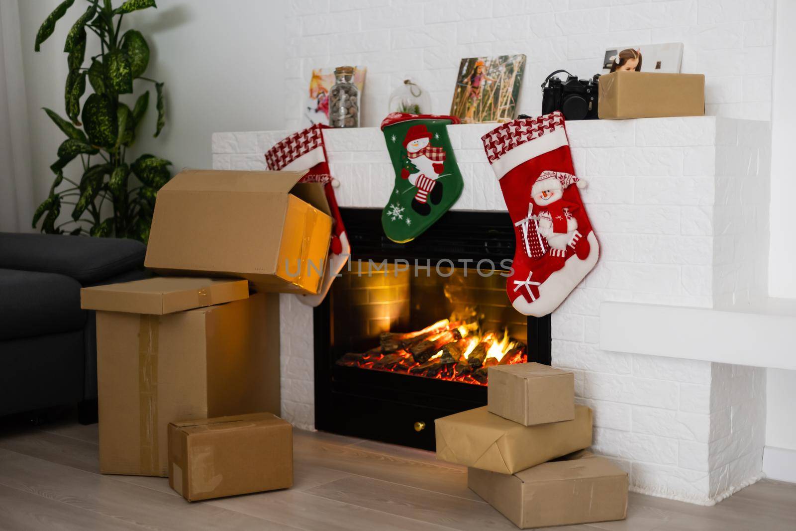 Vintage packages, delivery boxes near fireplace, Christmas by Andelov13
