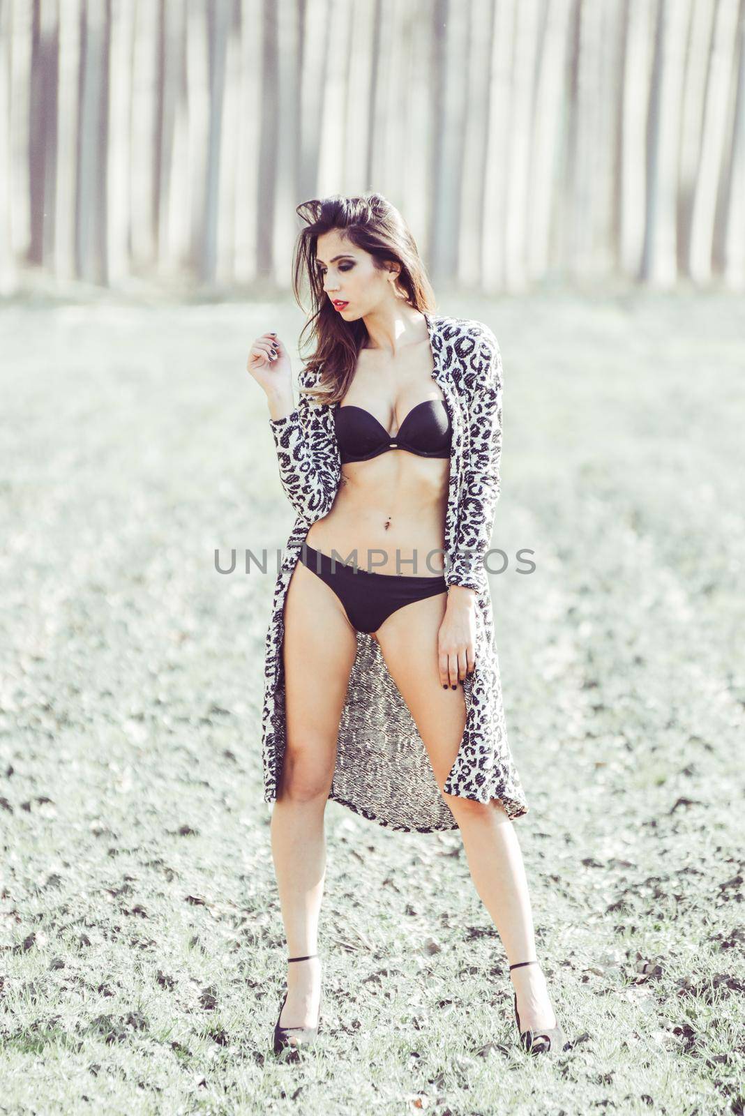 Portrait of beautiful young woman in underwear in a forest