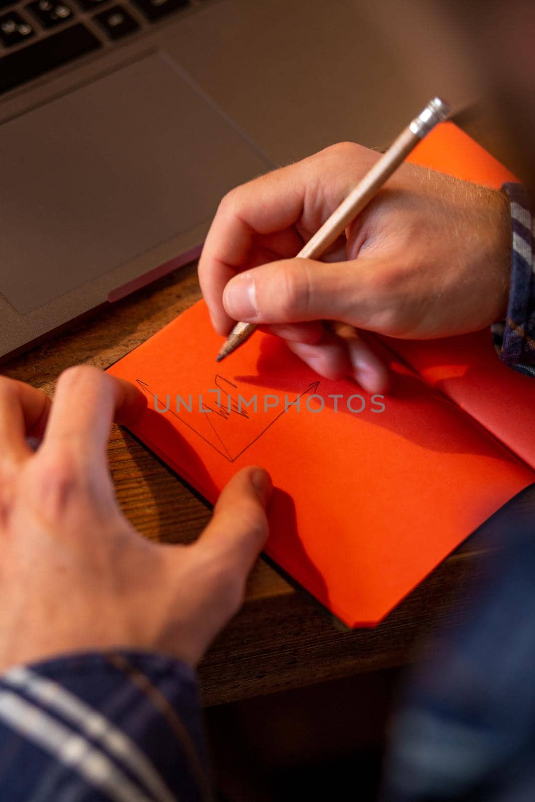 Cropped image of casual business man or freelancer planning his work on notebook, working on laptop computer with smart phone, cup of coffee on table at coffee shop or home office, working from cafe concept