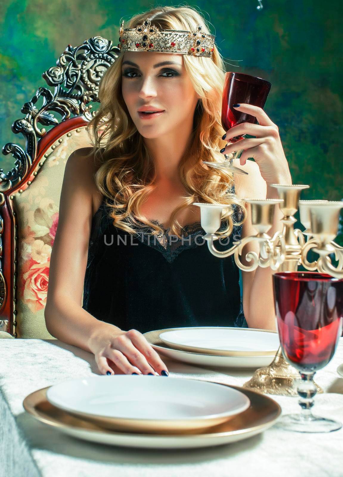 young blond woman wearing crown in fairy luxury interior with empty antique frames total wealth concept by JordanJ