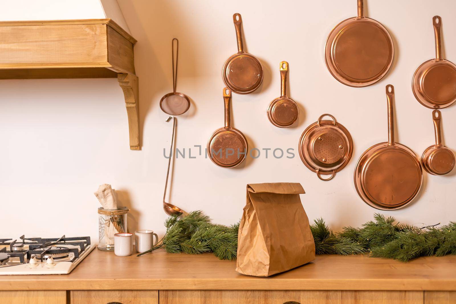 Mock-up of big brown paper package with handles, blank craft shopping bag with area for your logo or design, white wall in the background, food delivery concept