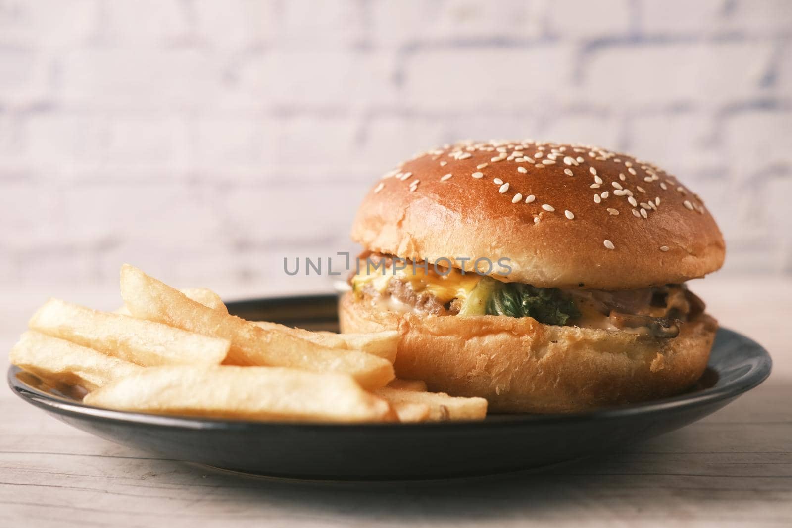 junk foods on plate on wooden table close up ,